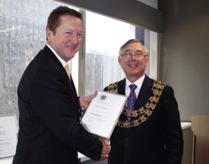 Michael Pennell being awarded an ANZIIF Service Award for his services to the insurance industry. This is a picture of Michael getting the award.